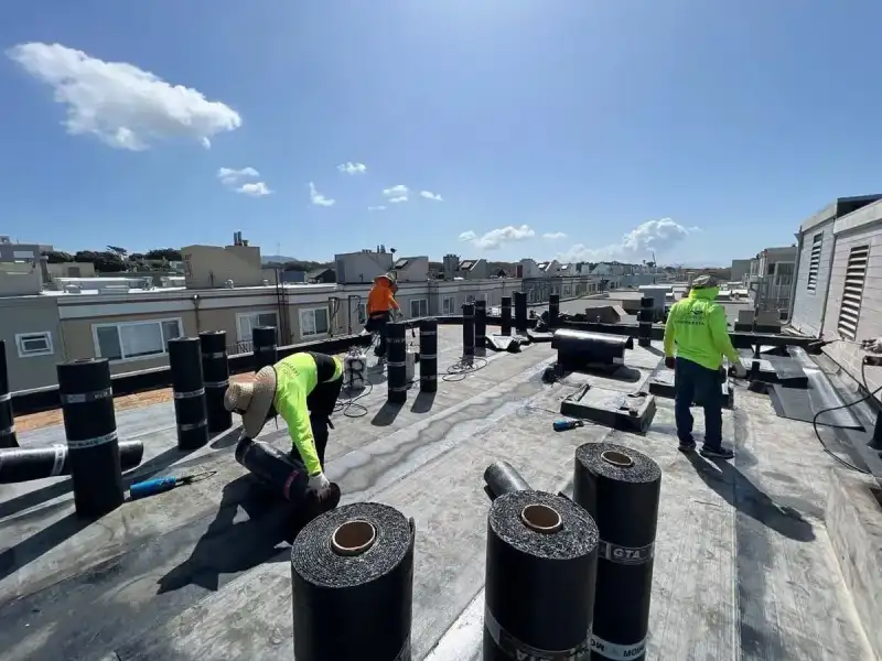Roofing crew installing a replacement flat roof